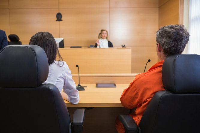 Lawyer and client listening to judge 

